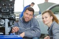 man and woman mechanics in car workshop