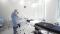 Man and woman medical doctors in the procedure room. Action. Nurse and the surgeon preparing surgical instruments and Royalty Free Stock Photo