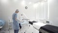 Man and woman medical doctors in the procedure room. Action. Nurse and the surgeon preparing surgical instruments and Royalty Free Stock Photo