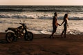 A man and a woman meet the sunset on the island of Bali. A couple in love on the beach meets the sunset. Royalty Free Stock Photo