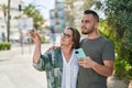 Man and woman mother and daugther using smartphone at park Royalty Free Stock Photo