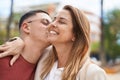 Man and woman mother and son hugging each other and kissing at park Royalty Free Stock Photo