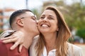 Man and woman mother and son hugging each other and kissing at park Royalty Free Stock Photo