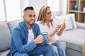 Man and woman mother and son using smartphone drinking coffee at home Royalty Free Stock Photo