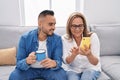 Man and woman mother and son using smartphone drinking coffee at home Royalty Free Stock Photo