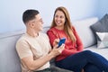 Man and woman mother and son using smartphone sitting on sofa at home Royalty Free Stock Photo