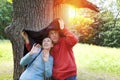 Man and the woman near an oak hide from a rain in the summer day Royalty Free Stock Photo