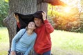 Man and the woman near an oak hide from a rain in the summer day Royalty Free Stock Photo