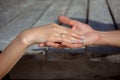 Man and woman, newlyweds holding hands with blurred background. Royalty Free Stock Photo