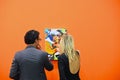 Man and a woman,observing a picture, at an art exhibition, before the formal opening, in Turin,Italy