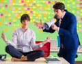 Man and woman in the office with many conflicting priorities in Royalty Free Stock Photo