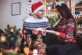 Man and woman opens Christmas gift at home Royalty Free Stock Photo