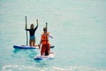 Man and woman paddling on sup board Royalty Free Stock Photo