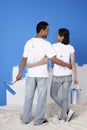 Man and woman with paint and paint roller looking at each other. Conceptual image Royalty Free Stock Photo