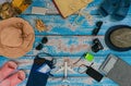 Man and woman pair vacation accessories on the blue wooden boards. Concept: family going on vacation. Royalty Free Stock Photo