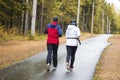 A man and woman in the park is running. Sports on the street Royalty Free Stock Photo