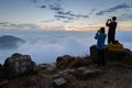 Man and woman photographing at the Lantau Peak at dawn