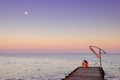 Man and woman on a pier in the moonlight Royalty Free Stock Photo