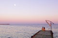 Man and woman on a pier on sunset Royalty Free Stock Photo