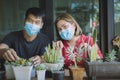 Man and Woman planting succulent at little home garden