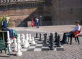 Man and woman play a chess near a castel Sant'Angelo