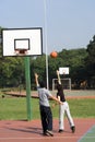 Man and Woman Playing Basketball - Vertical Royalty Free Stock Photo