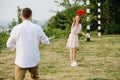 Man and woman playing frisbee in a park next to a river and forest ridge Royalty Free Stock Photo