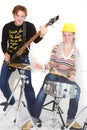 Man and woman playing guitar and drums