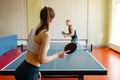 Man and woman playing ping pong indoors Royalty Free Stock Photo