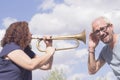 Man and woman playing trumpet