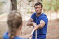 Man and woman playing tug of war during obstacle course Royalty Free Stock Photo