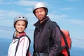 Man, woman and portrait with smile for paragliding, extreme sport and outdoor by sea in sunshine. Happy couple, fitness