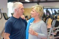 Man and woman posing in gym and smiling Royalty Free Stock Photo