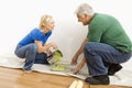 Man and woman pouring paint.