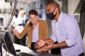 Man and woman in protective masks in panic looking for a solution on the computer in quest room Royalty Free Stock Photo