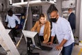 Man and woman in protective masks in panic looking for a solution on the computer in quest room Royalty Free Stock Photo