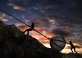 Man and Woman Pulling and Pushing Uphill A Big Rock Together With a Metal Chain against sunset background.