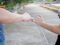 Man and woman in relationship crossing pinky finger as promised