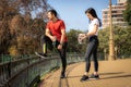 Man and woman resting together after jogging in park Royalty Free Stock Photo