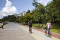 Man and woman ride bicycles in Moda