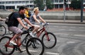 Man and woman ride bikes.