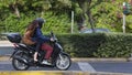 Man and woman ride a motorbike, Athens