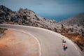 Man and woman ride together on bicycle in mountains, Active couple on the road