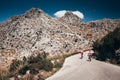 Man and woman ride together on road bicycle. Adventure in big mountains