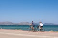 Man and woman riding a bikes by the sea