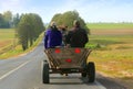 Man and woman riding in a carriage