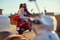 Man and woman riding motor scooter in city