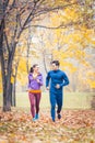 Man and woman running as fitness sport in an autumn park Royalty Free Stock Photo