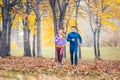 Man and woman running as fitness sport in an autumn park Royalty Free Stock Photo