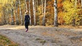 Man and woman running on the autumn woods